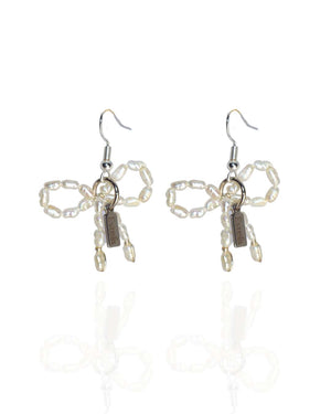 Earrings with pearl bows - image