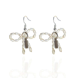 Earrings with pearl bows - image