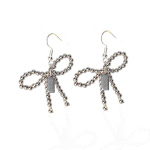 Earrings with white gold bows - image