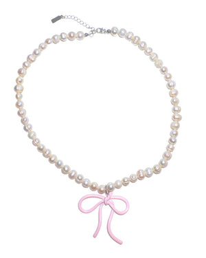 Pearl necklace with pink bow charm - image